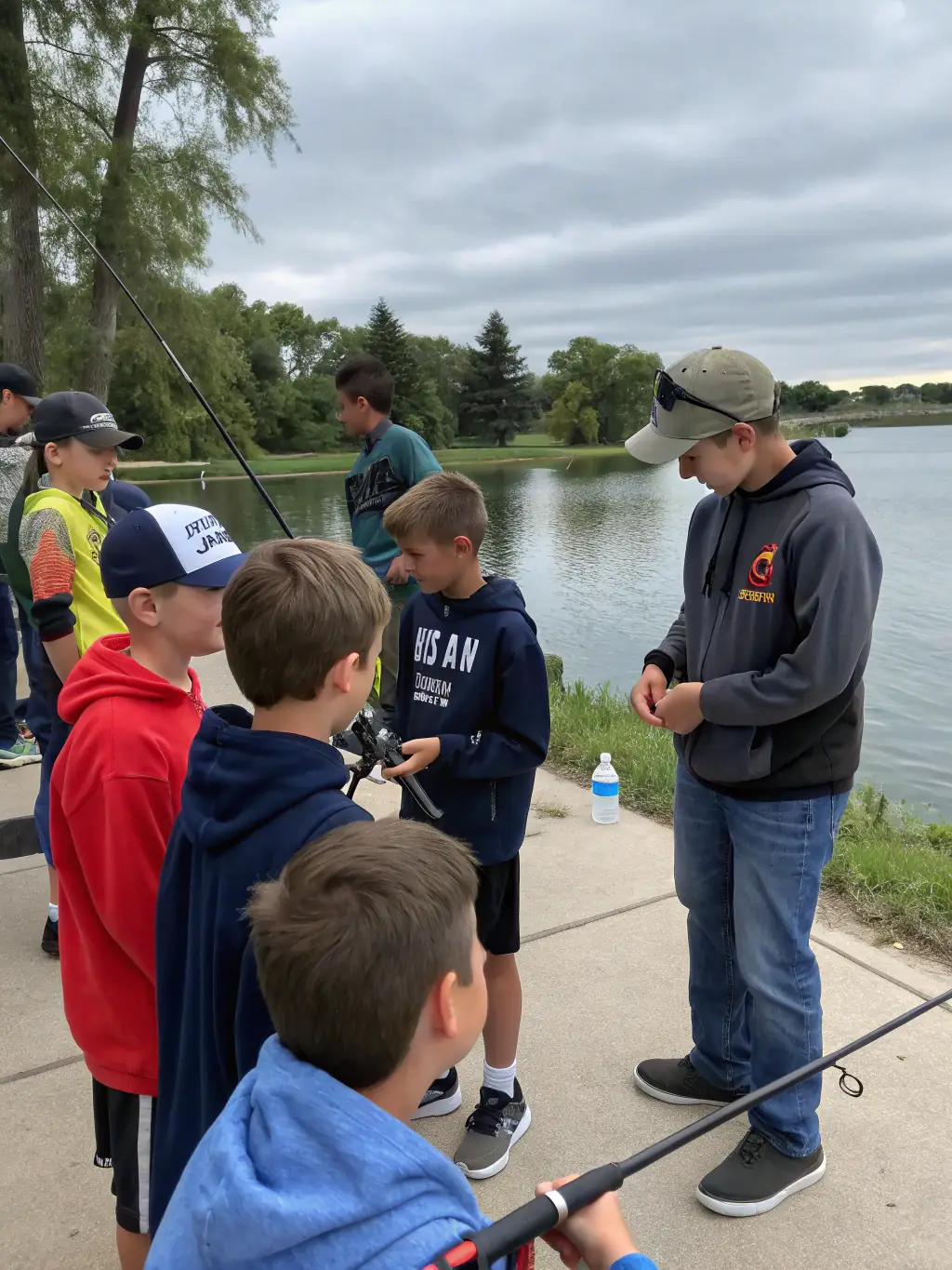A group of anglers participating in a competitive angling training session, focusing on casting techniques, with an instructor providing guidance.
